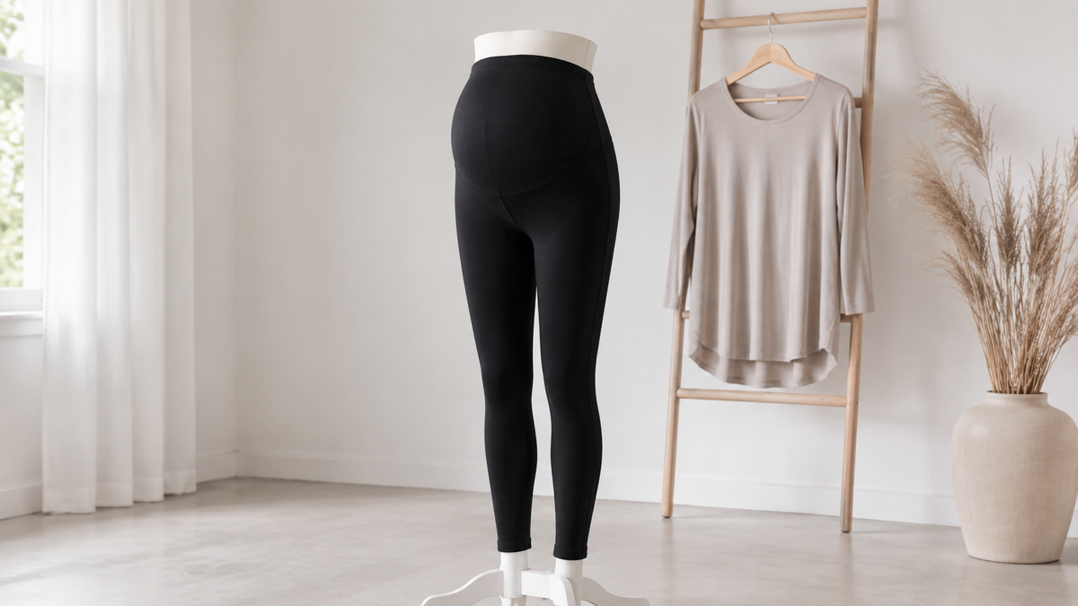 Black maternity leggings displayed in a calm neutral room