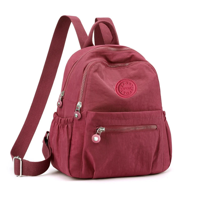 Neutral Style Backpack for Men and Women, Suitable for Travel and Photography Made of Nylon Material, with a Round Logo Design.
