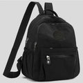 Neutral Style Backpack for Men and Women, Suitable for Travel and Photography Made of Nylon Material, with a Round Logo Design.