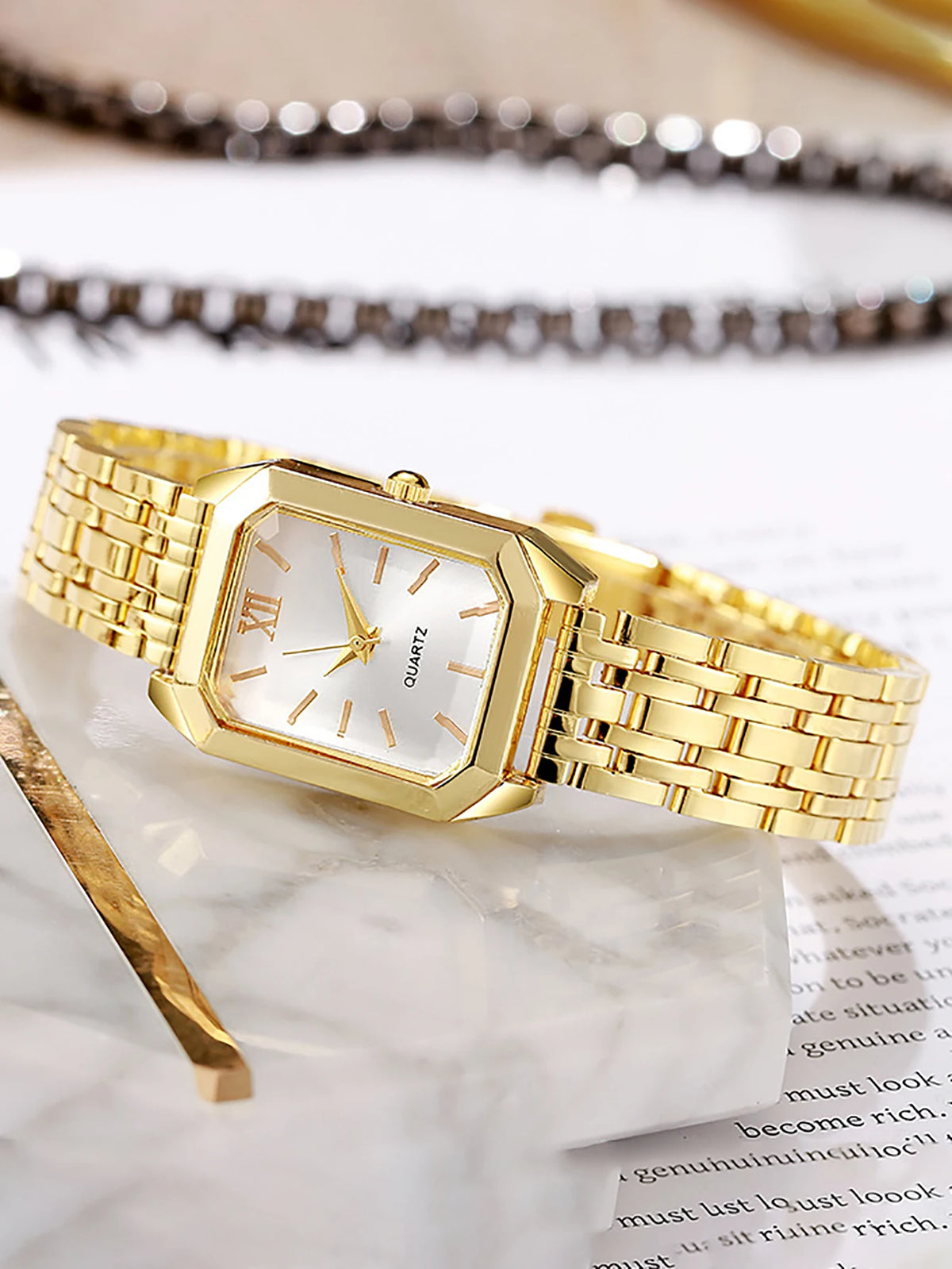A lady's compact quartz watch and a set of hollowed-out and jeweled decorations, suitable as a holiday gift, without the box.